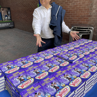 Frank Cottrell-Boyce with hundreds of copies of *The Wonder Brothers*. We gave a book to every child who came to the performance.