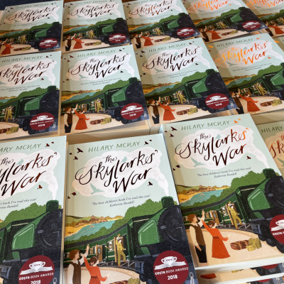 Hundreds of copies of *The Skylarks' War* by Hilary McKay, ready to be given to our audience