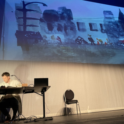 Sydney Smith painting on stage