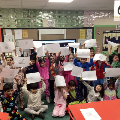 Children from Cannon Park primary showing off their own drawings of Peggy!