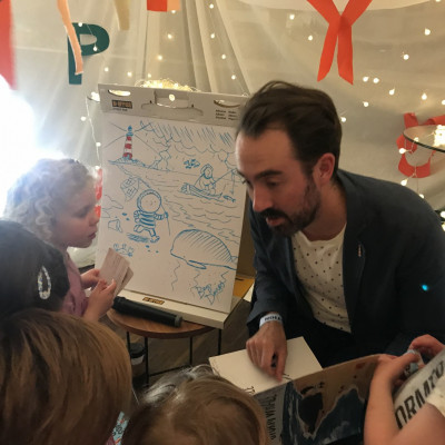 Benji Davies talking to children at the Old Vic Bicentenary celebration event in 2018