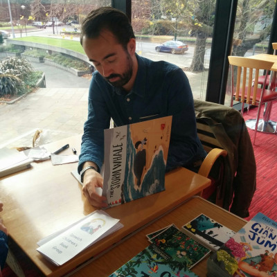 Benji Davies signs books after his performance in Ipswich is 2015.