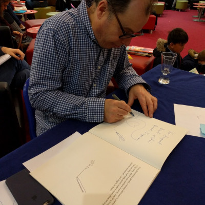 Bruce Ingman signs books after his performance in Warwick