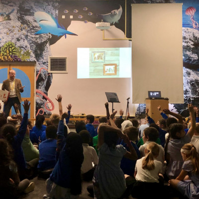 Chris Naylor-Ballesteros talks to children