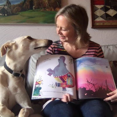 Jo Empson reading her book *Jungle Jamboree* with her dog Wilfred