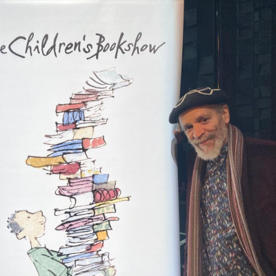 John Agard with the Children's Bookshow banner in Newcastle