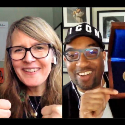 Kwame Alexander showing his Newbery Medal Award, at his Digital festival performance to celebrate World Book Day