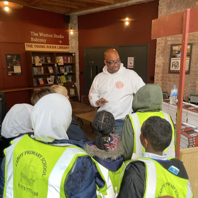 Kwame Alexander helped give out books to the children