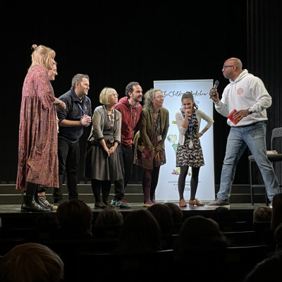 Several teachers got up on stage to play a poetry game with Kwame!