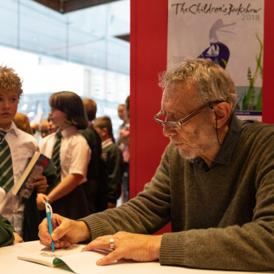 Michael signs books for the children after his Leicester performance