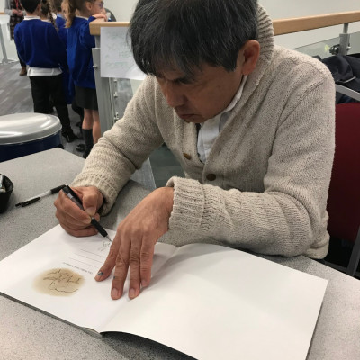 Satoshi signing books after his performance at Warwick Arts Centre