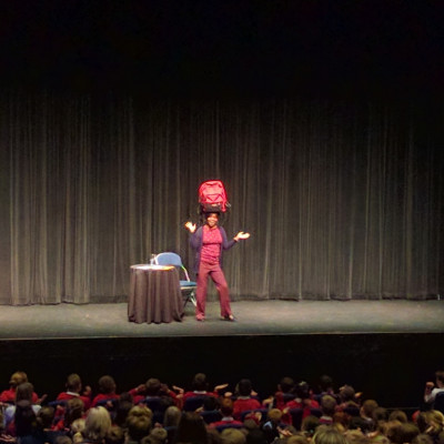 Valerie performs the Pinda Cake song, balancing her rucksack on her head!