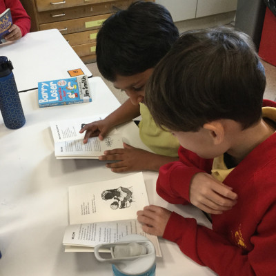 Children enjoying their free copies of *Stars with Flaming Tails* by Valerie Bloom