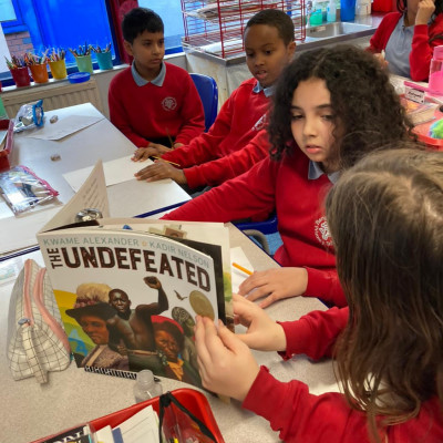 Children reading *The Undefeated* at Bangabandhu Primary